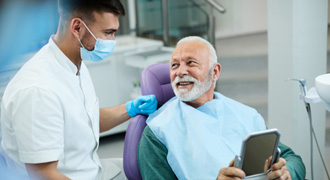 Man smiling at dentist during checkup